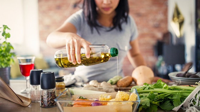 woman cooking with cooking oil